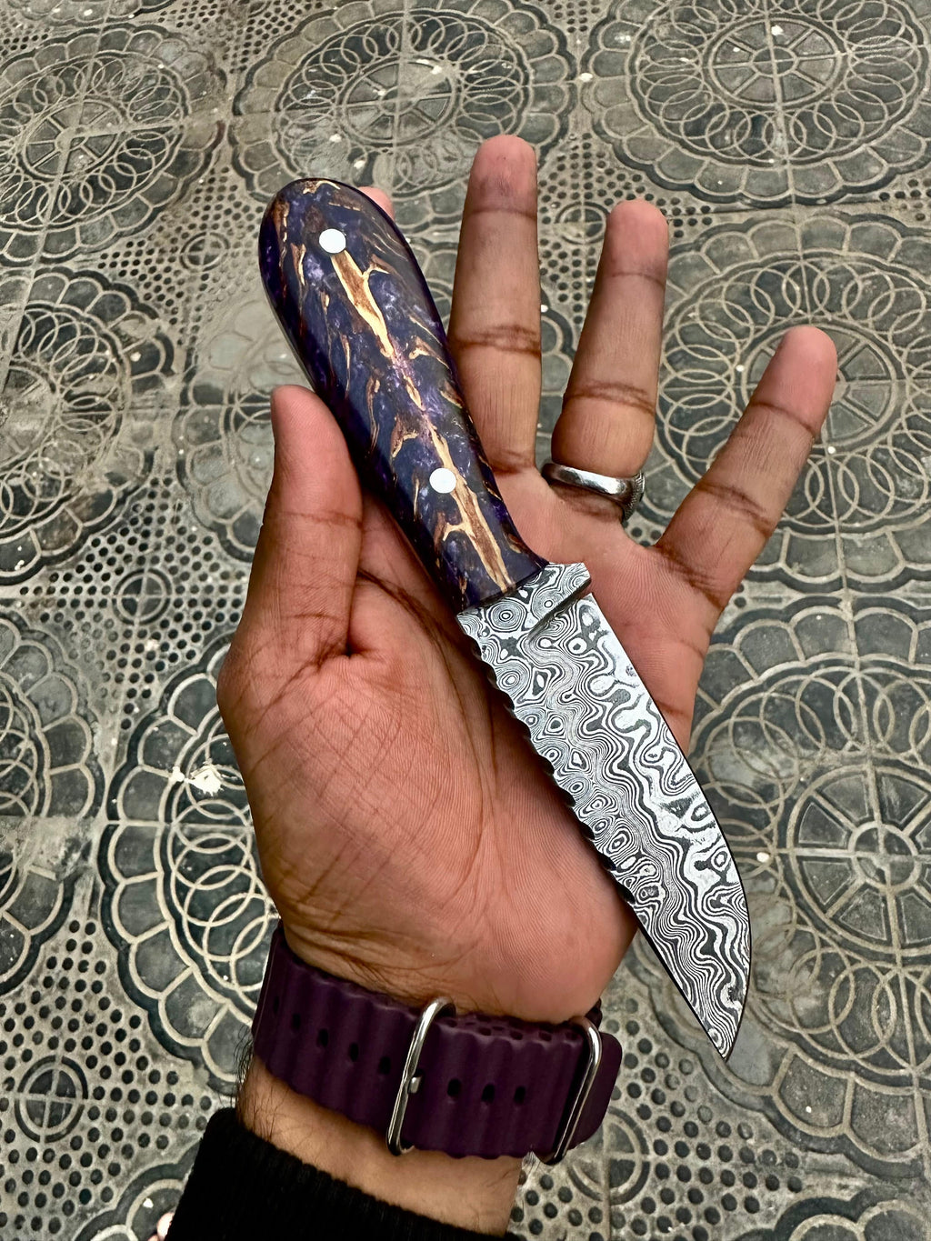 Handsome hunting knife with a sharp blade and wooden handle, displayed on a dark background.
