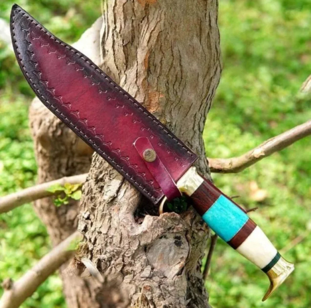 Custom handmade Damascus steel Bowie knife with brass guard and colorful bone handle, includes leather sheath.