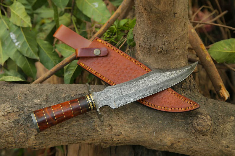 Handcrafted Damascus Steel Bowie Knife with rosewood handle, brass accents, Damascus guard, and leather sheath by Knives Gear Garage.
