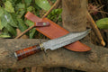 Handcrafted Damascus Steel Bowie Knife with rosewood handle, brass accents, Damascus guard, and leather sheath by Knives Gear Garage.