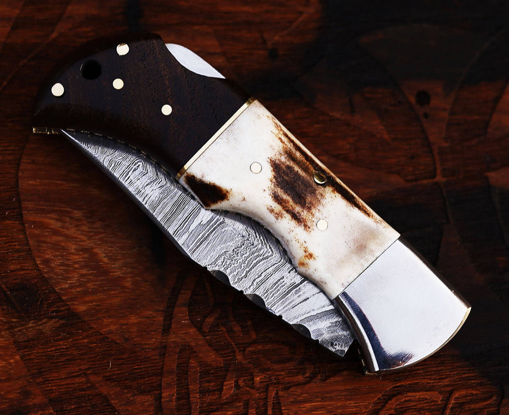 Damascus steel folding pocket knife with stag and rosewood handle, handmade by CSK Forged.