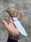 D2 hunting knife by Knives Gear Garage with a sharp blade and ergonomic handle, suitable for outdoor and hunting tasks.