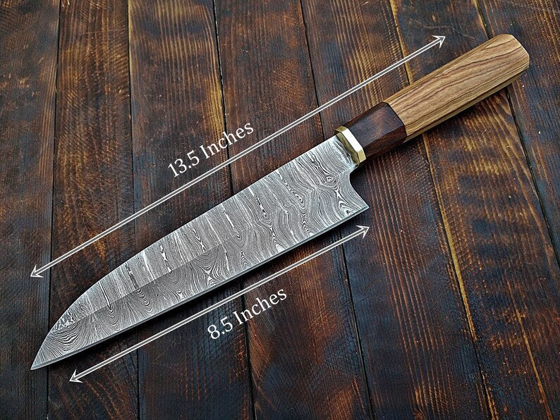 Custom handmade Damascus chef knife by Knives Gear Garage with a patterned blade and ergonomic wood handle.