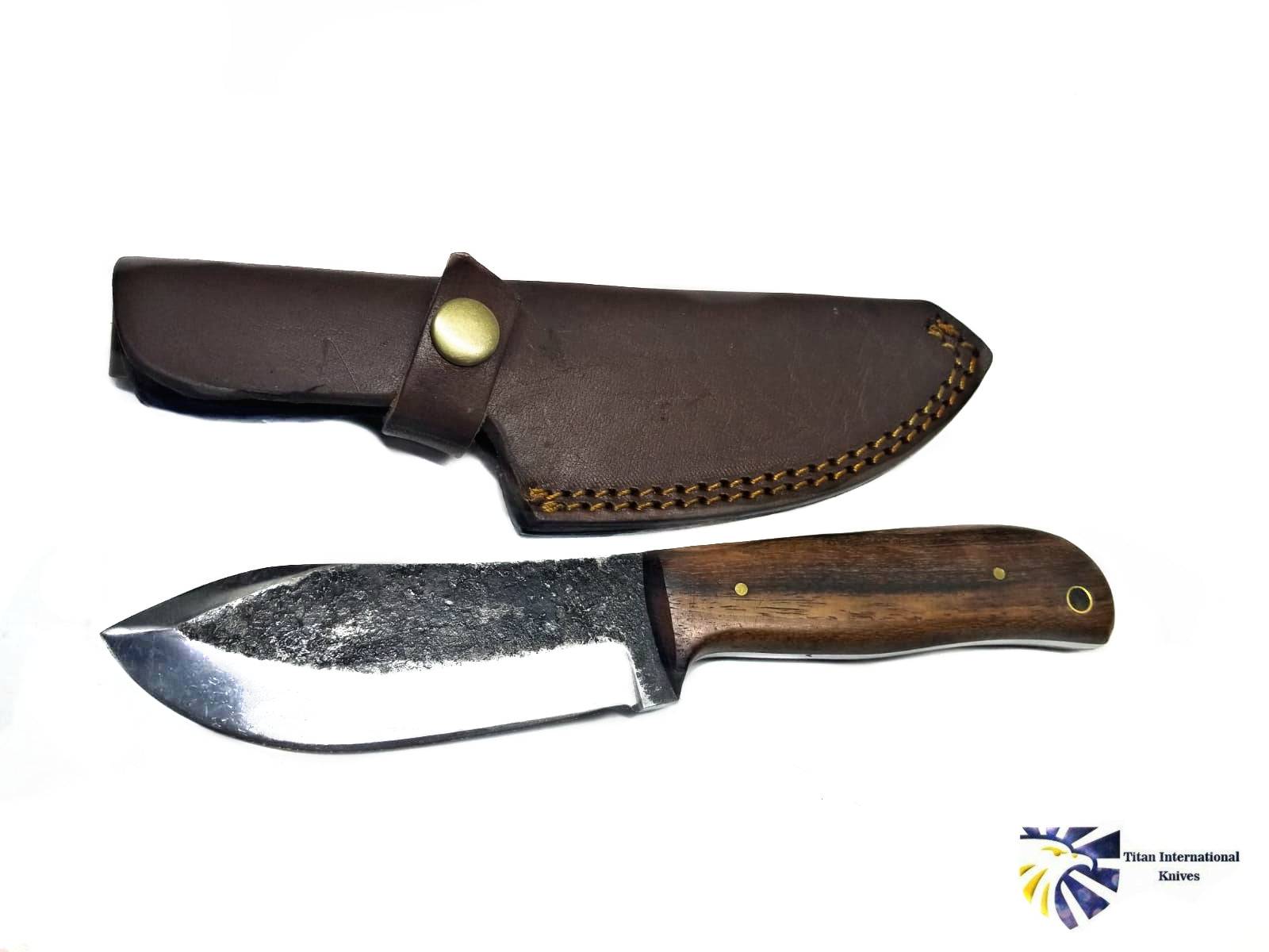 Hand-forged Titan International K Puma Skinner knife with custom carbon forged blade, featuring a sleek, sharp design for outdoor use.