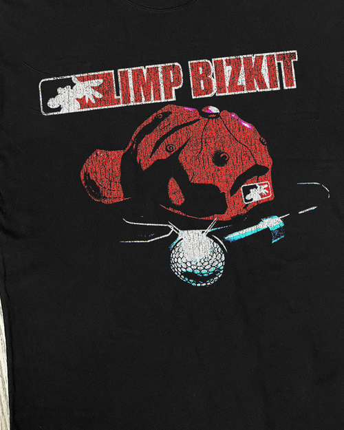 Close-up of Parallel Limp Bizkit black cut-off shirt showcasing distressed fabric and band logo detail.