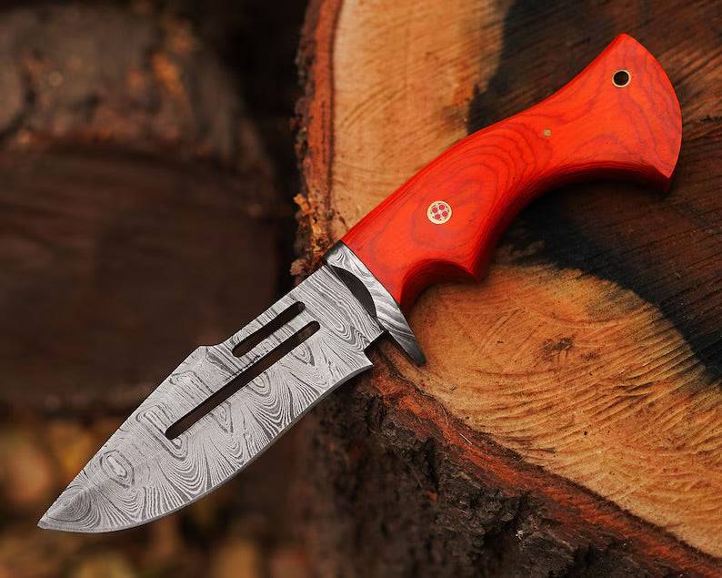 Damascus steel hunting knife by cskforged with a textured handle and sharp blade, suited for outdoor hunting and survival.