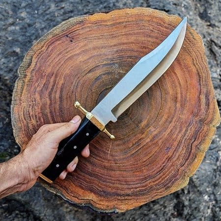 Handmade Bowie knife with D2 steel blade and buffalo horn handle, featuring detailed craftsmanship and natural materials.