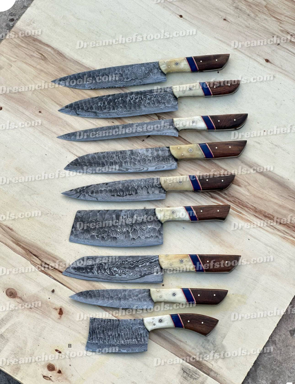 Handmade kitchen knife set from Knives Gear Garage with sleek stainless steel blades and ergonomic handles on a wooden countertop.