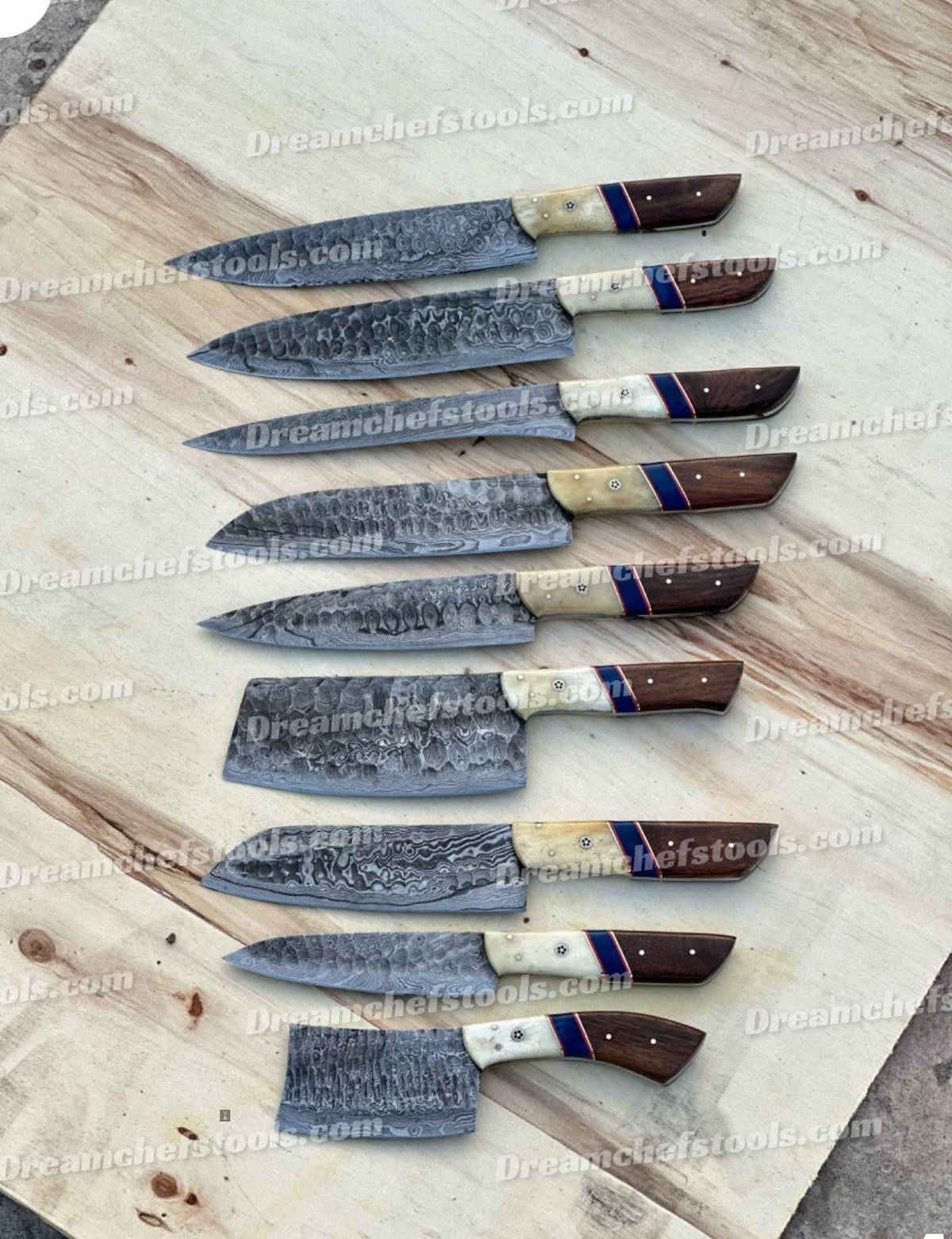 Handmade kitchen knife set from Knives Gear Garage with sleek stainless steel blades and ergonomic handles on a wooden countertop.