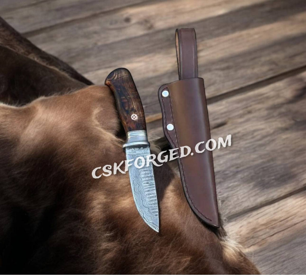 Hand-forged Damascus tactical brawler's knife from cskforged, featuring a sharp hunting knife blade and sturdy handle.
