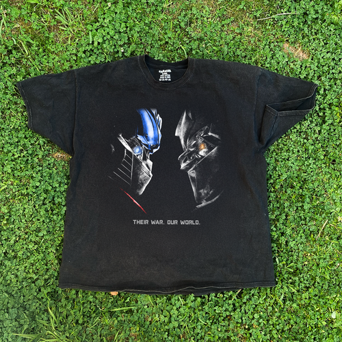Vintage washed black Transformers 'Their War. Our World.' T-shirt by Parallel featuring a graphic design with iconic Transformers characters.