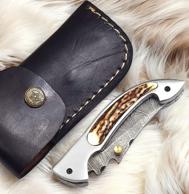 Handmade Damascus pocket knife with stag horn handle and 3-inch blade from Damascus Knife Store.