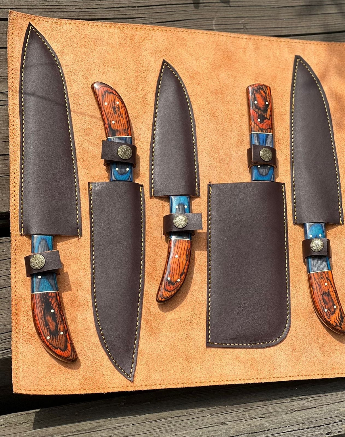 Handmade D2 steel kitchen knife set with wooden handles, featuring multiple chef and utility knives for culinary use.