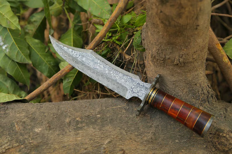 Handcrafted Damascus Steel Bowie Knife with rosewood and brass handle, Damascus steel guard, and leather sheath.