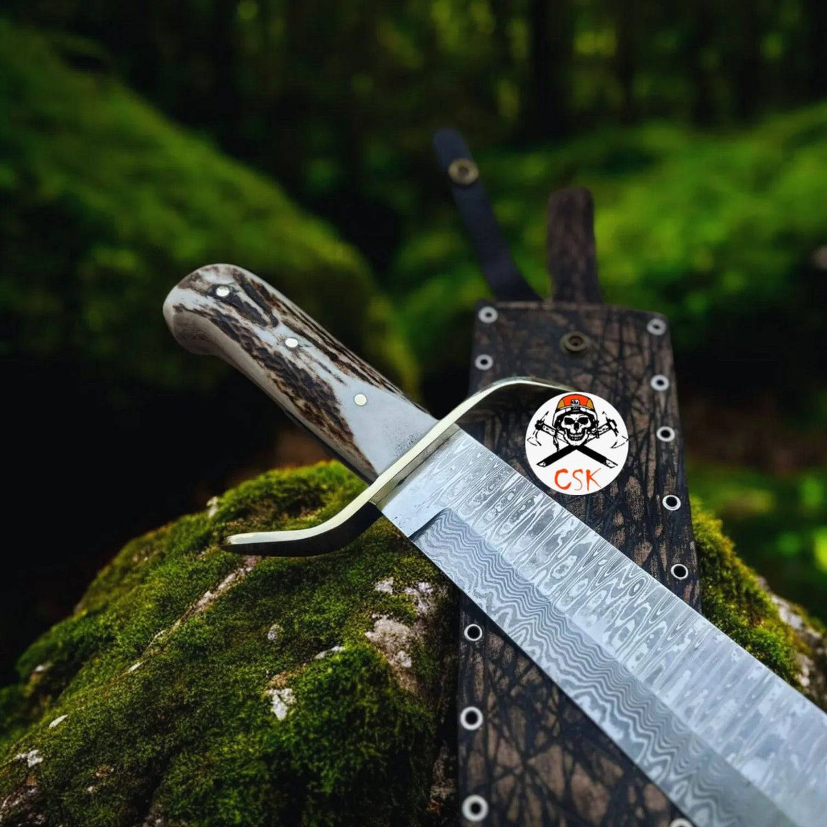 Damascus stag hunting knife by cskforged with custom leather sheath, featuring a detailed Damascus steel blade and stag handle.