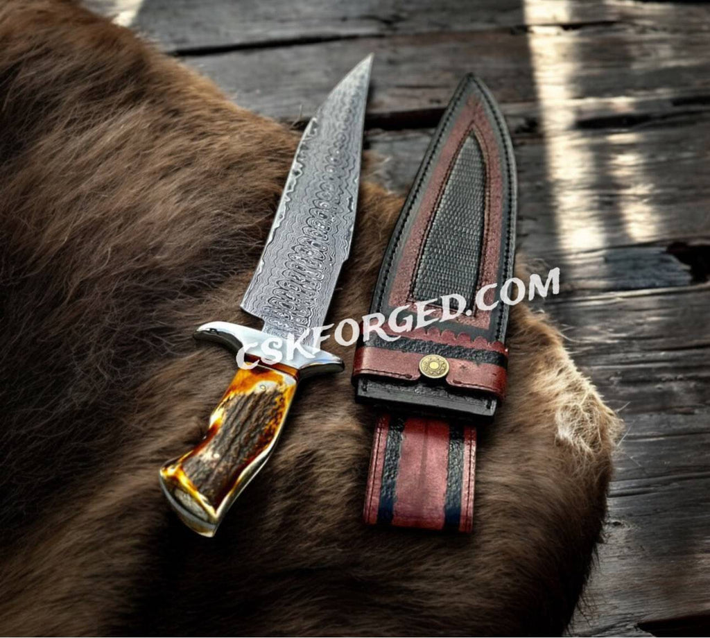 Handforged Damascus Steel 'Dragon Slayer' hunting knife by cskforged with stag handle, collector’s edition, detailed blade and handle features.