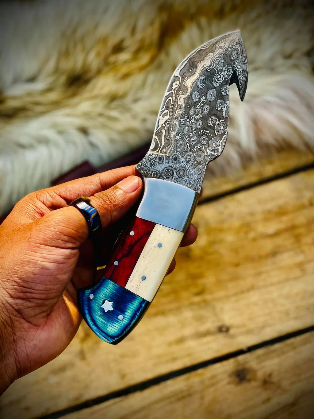 Handmade Texas flag handle gut hook skinning knife by Knives Gear Garage, ideal for hunting and outdoor skinning tasks.