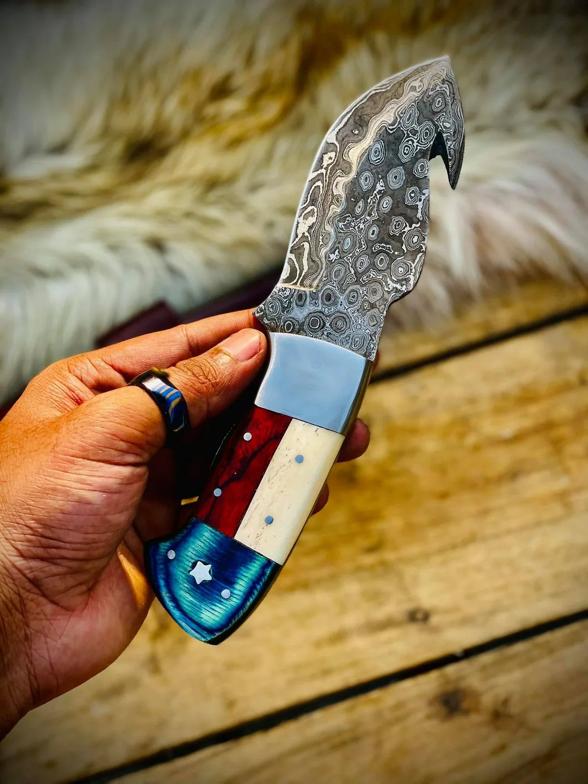 Handmade Texas flag handle gut hook skinning knife by Knives Gear Garage, ideal for hunting and outdoor skinning tasks.