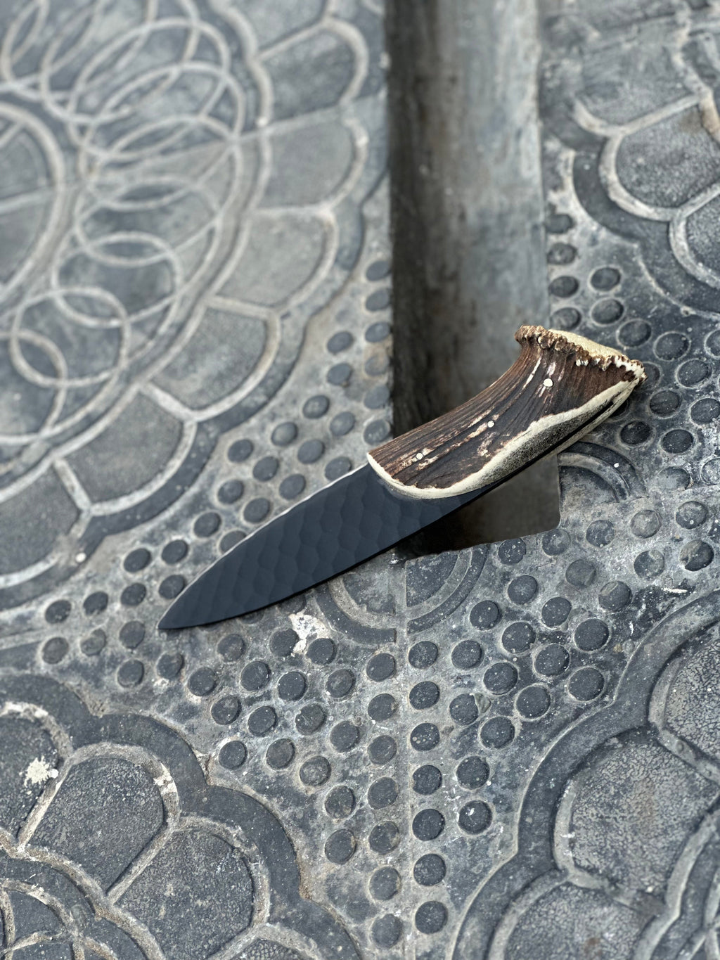 Hand forged steel hunting knife with leather handle, featuring a sharp blade and rugged design by Knives Gear Garage.