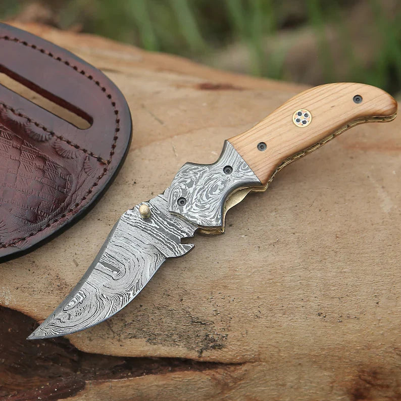 Damascus pocket knife by Knives Gear Garage with intricate layered steel blade and ergonomic handle for everyday carry.