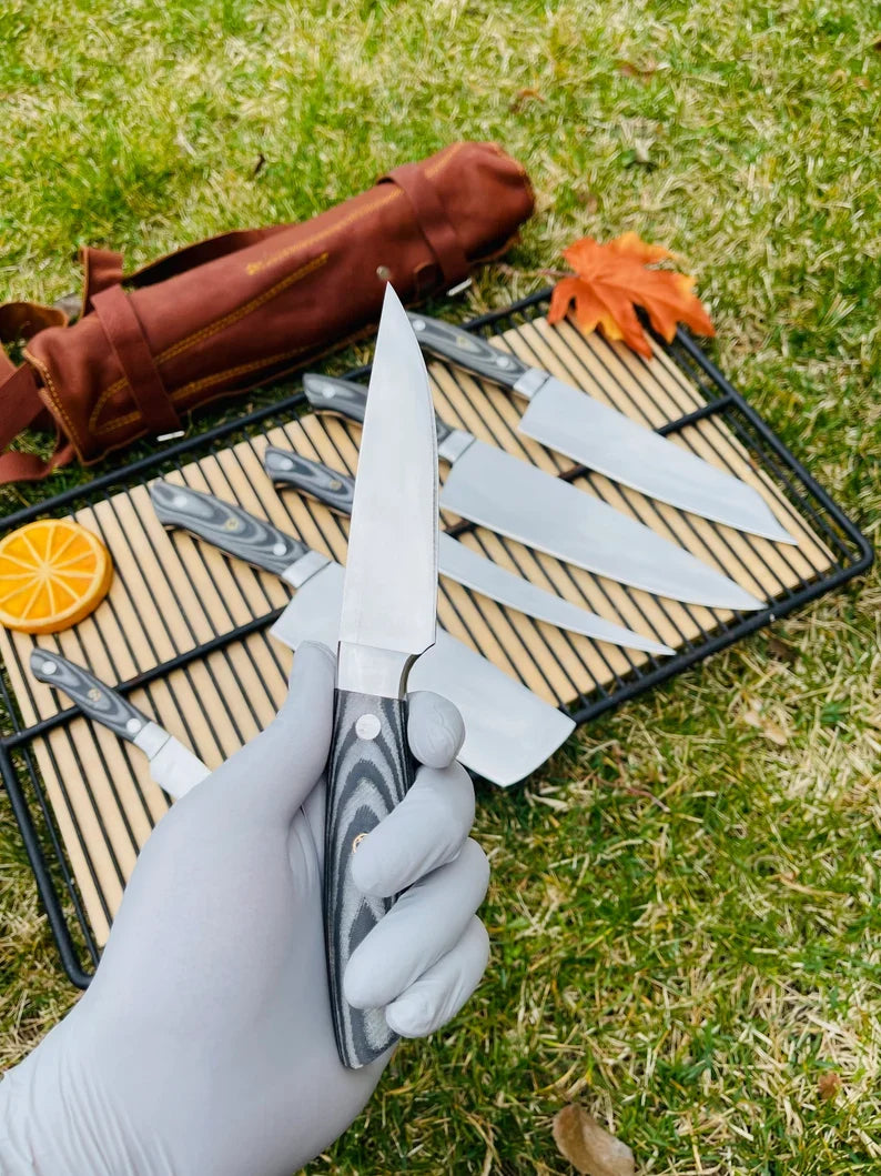Custom handmade J2 Steel kitchen knife set by Knives Gear Garage with G10 handles, steel bolsters, and leather roll kit.