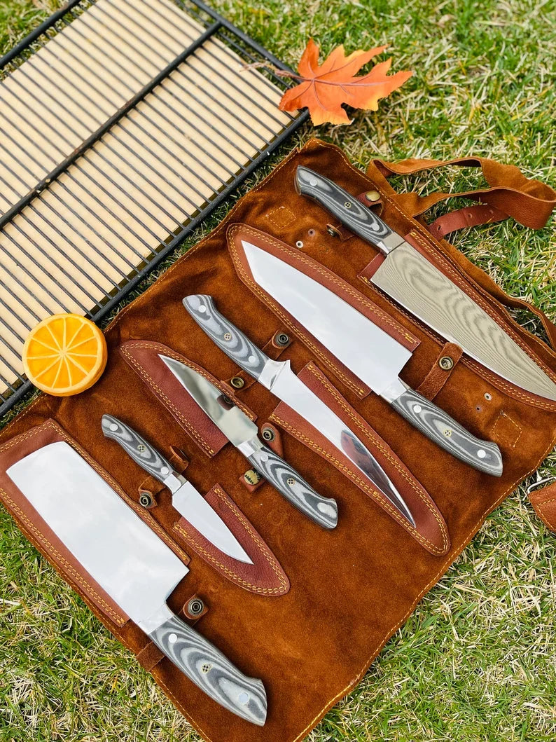 Handcrafted J2 Steel kitchen knife set with G10 handles and steel bolsters, displayed in a leather roll kit.