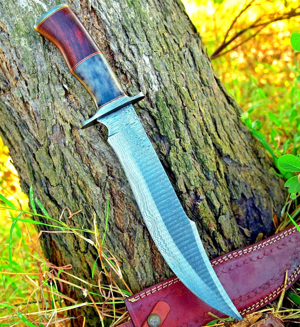 Handmade Damascus Steel Bowie Knife with rosewood and colored bone handle, steel guard, and leather sheath.