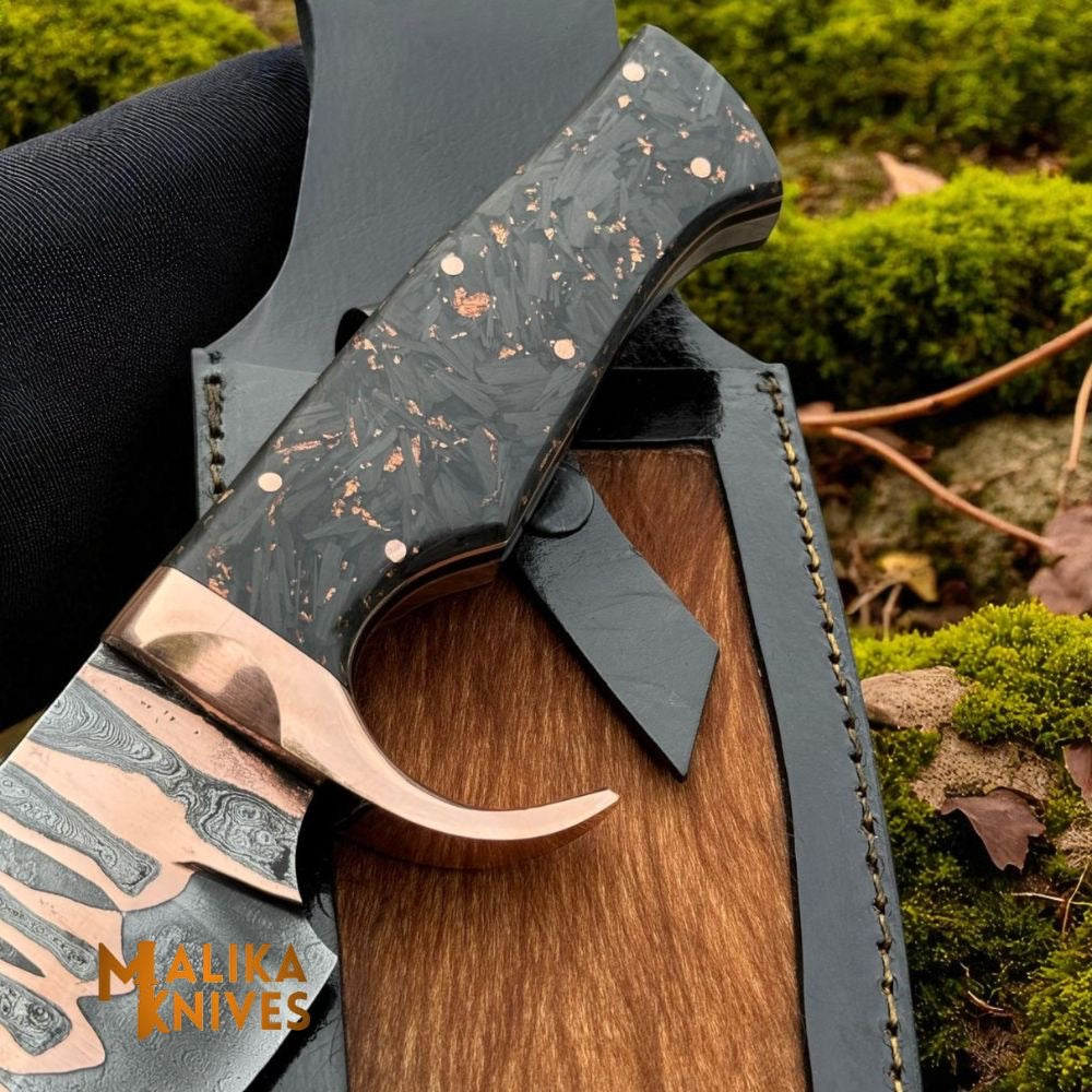 Copper Damascus Bowie knife with carbon fiber handle by Malika Knives, showcasing its detailed Damascus pattern and sleek handle design.