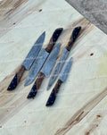 Set of stainless steel kitchen knives from Knives Gear Garage, featuring various sizes and blade types for versatile cooking tasks.