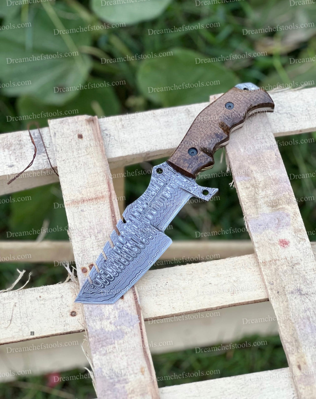 Handmade Damascus steel tracker knife with textured handle and sharp blade, crafted by Knives Gear Garage.