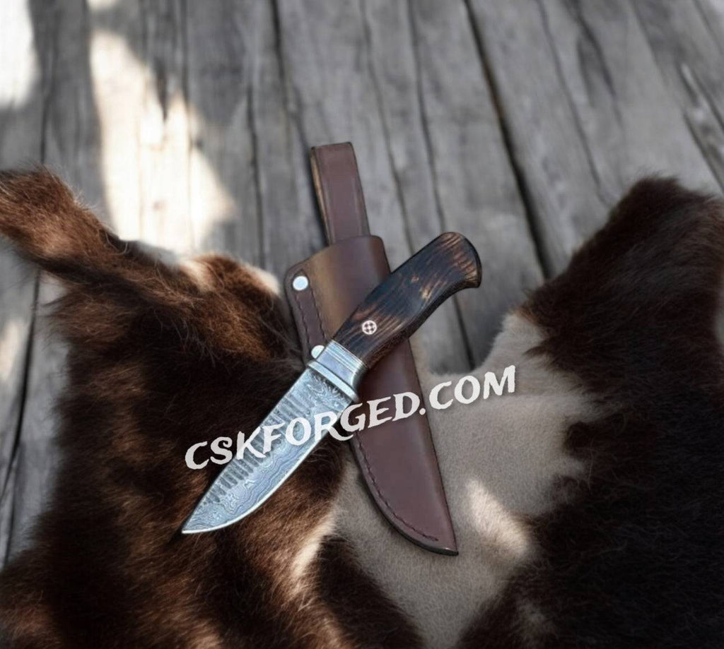 Hand-forged Damascus tactical brawler's knife by cskforged, featuring a sharp blade and sturdy handle for hunting and combat use.