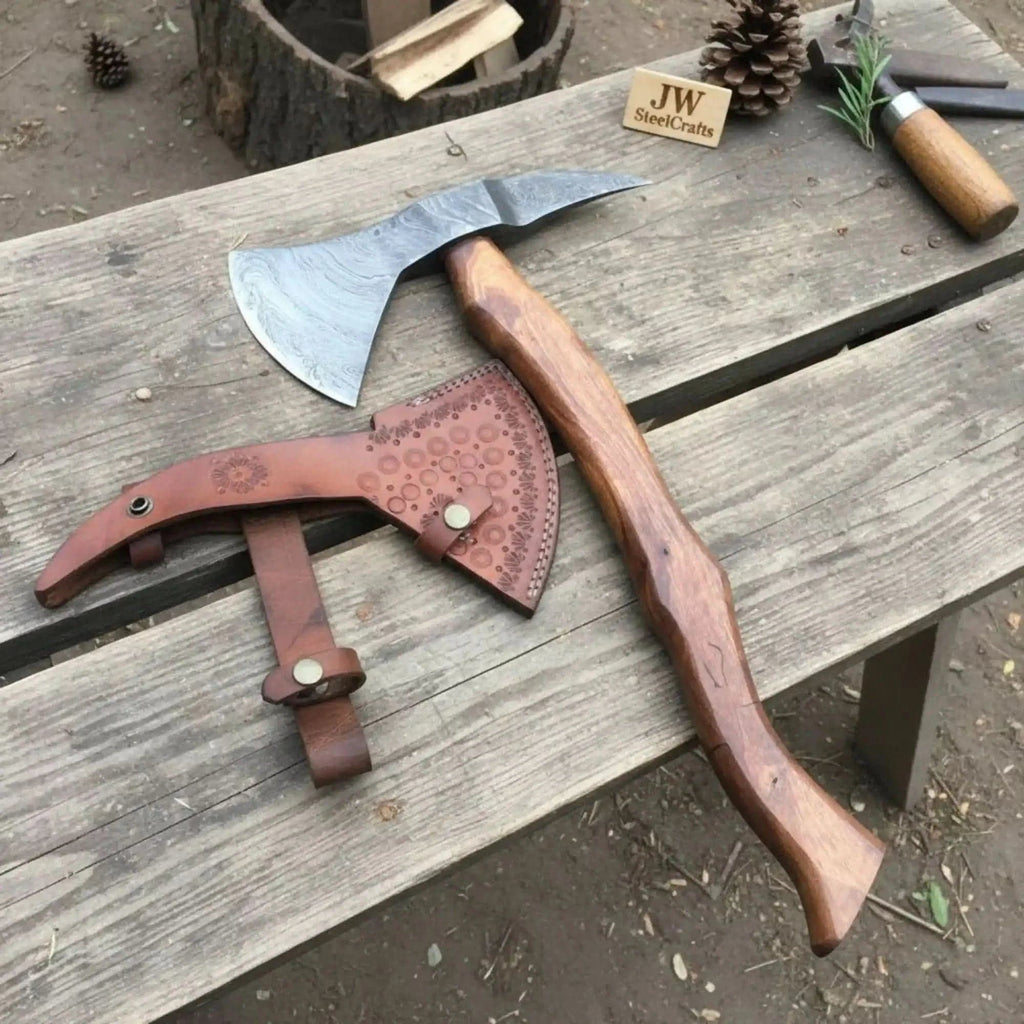 Handmade Damascus bearded spike tomahawk with forged spike poll by JW SteelCrafts, featuring a textured Damascus blade and wooden handle.
