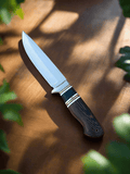 Hand-forged 10-inch J2 hunting knife with leather sheath by CSK Forged, featuring a sharp blade and durable handle for outdoor use.