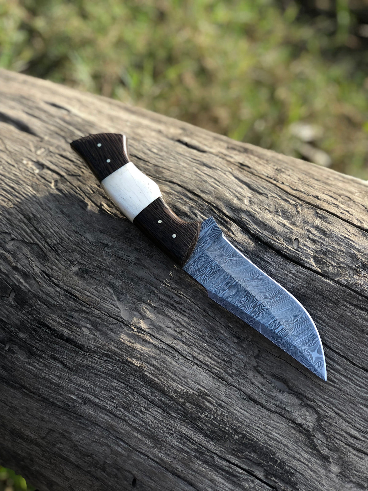 10.5-inch Wilderness Elite hunting knife by Knives Gear Garage with Damascus steel blade and bone-wenge wood handle.