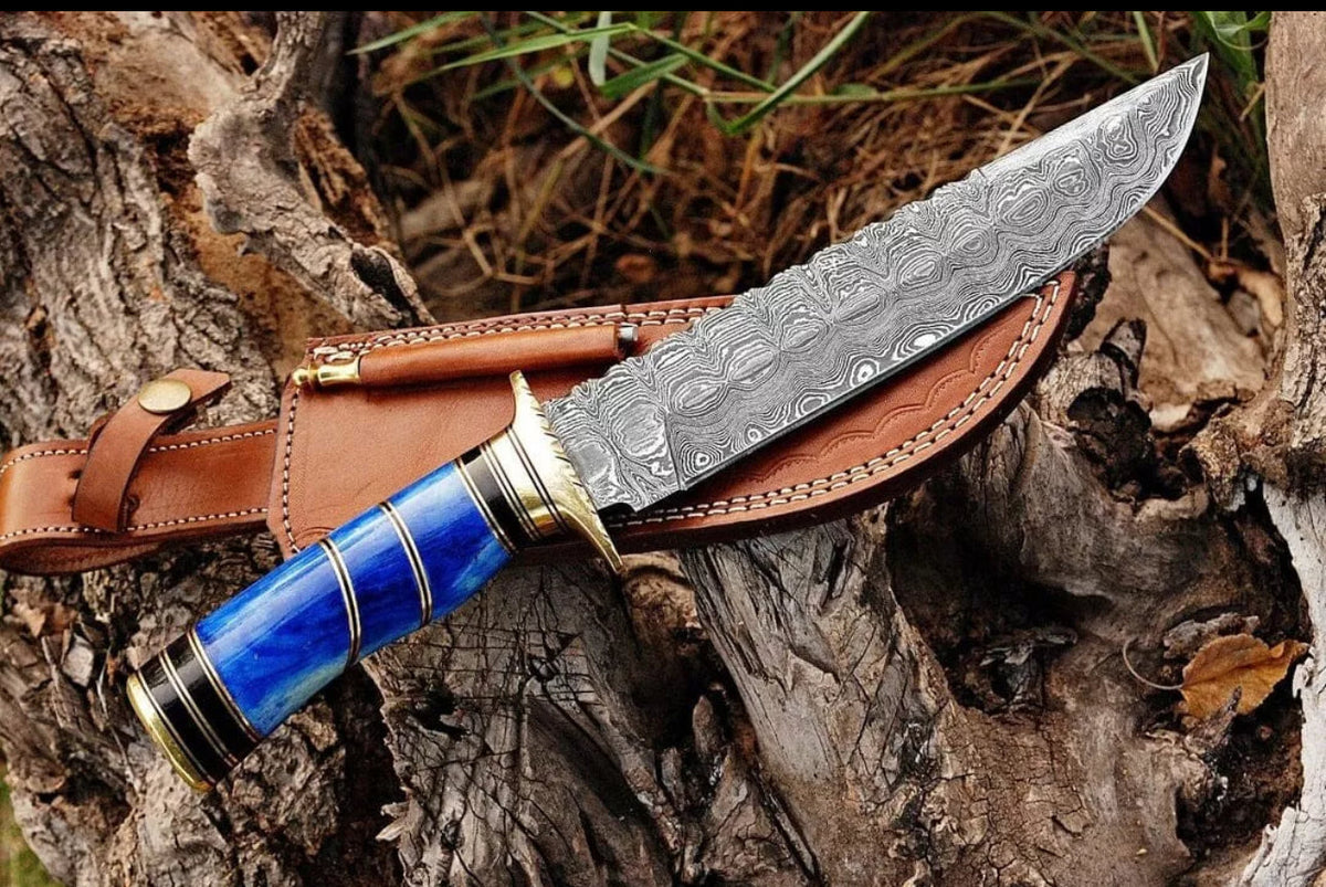 Handmade Damascus steel Bowie knife with brass guard, colorful bone handle, and leather sheath, crafted by Knives Gear Garage.