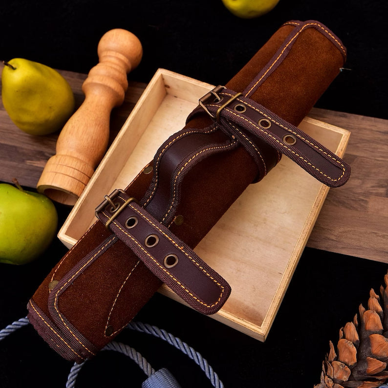 Set of stainless steel kitchen knives from Knives Gear Garage with black handles, displayed on a wooden cutting board.
