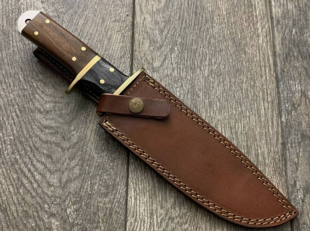 Handmade knife with brass guard and rosewood handle by cskforged, showing detailed craftsmanship and polished wood grip.