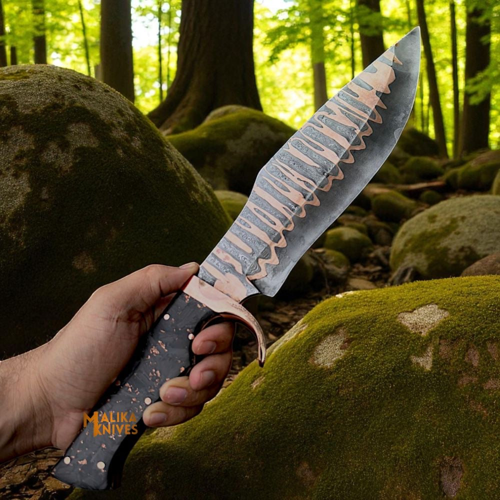 Damascus Bowie knife with copper blade and carbon fiber handle by MALIKA KNIVES, showcasing a sleek and durable design.