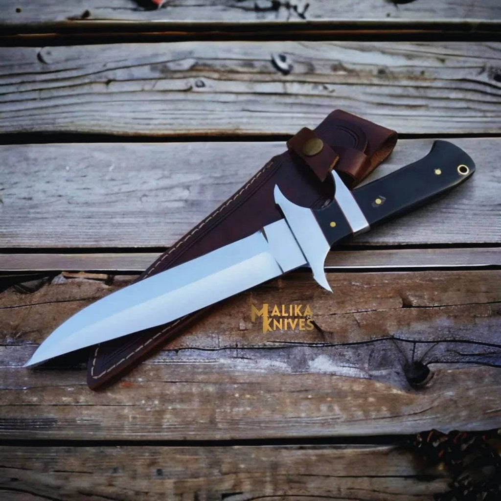 Close-up of MALIKA KNIVES Bowie knife with D2 steel blade and Micarta handle, showcasing its simple design and craftsmanship.