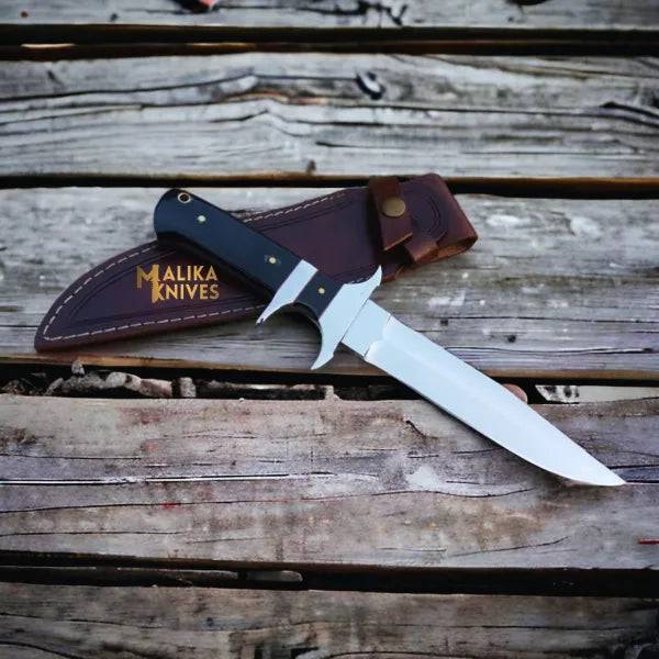 Close-up of MALIKA KNIVES Finger Guard Bowie Knife with D2 steel blade and Micarta handle, showing the knife's detailed design.