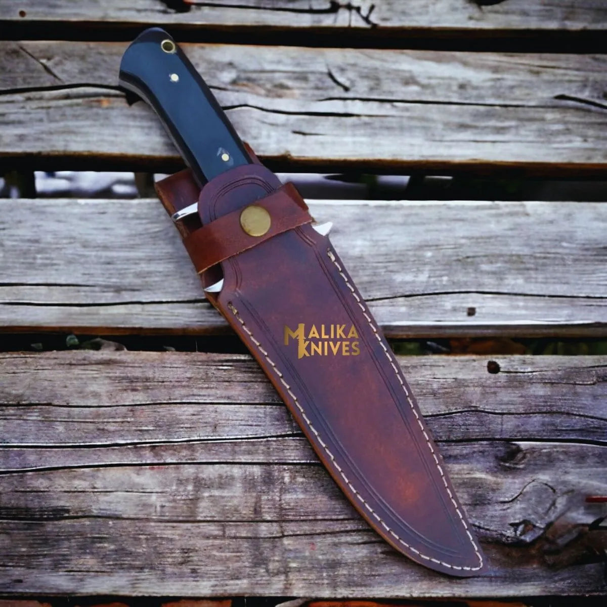 Close-up of MALIKA KNIVES Bowie knife with D2 steel blade and Micarta handle, showcasing its sleek design and craftsmanship.