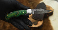 Folding hunting knife with a 3-inch Damascus blade, wood handle, and leather case by Knives Gear Garage.