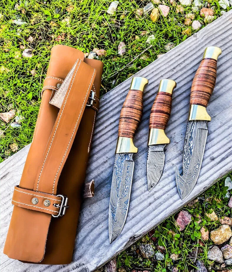 Wilderness Trio hunting knives set by Knives Gear Garage featuring Damascus steel blades, leather handles, brass guards, and leather roll