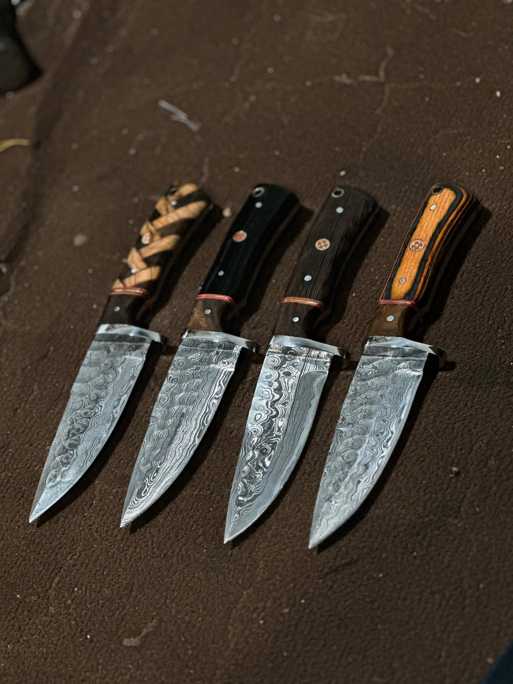 Hand-forged hunting knife by Knives Gear Garage with a sharp blade and leather handle, suitable for outdoor hunting and camping.