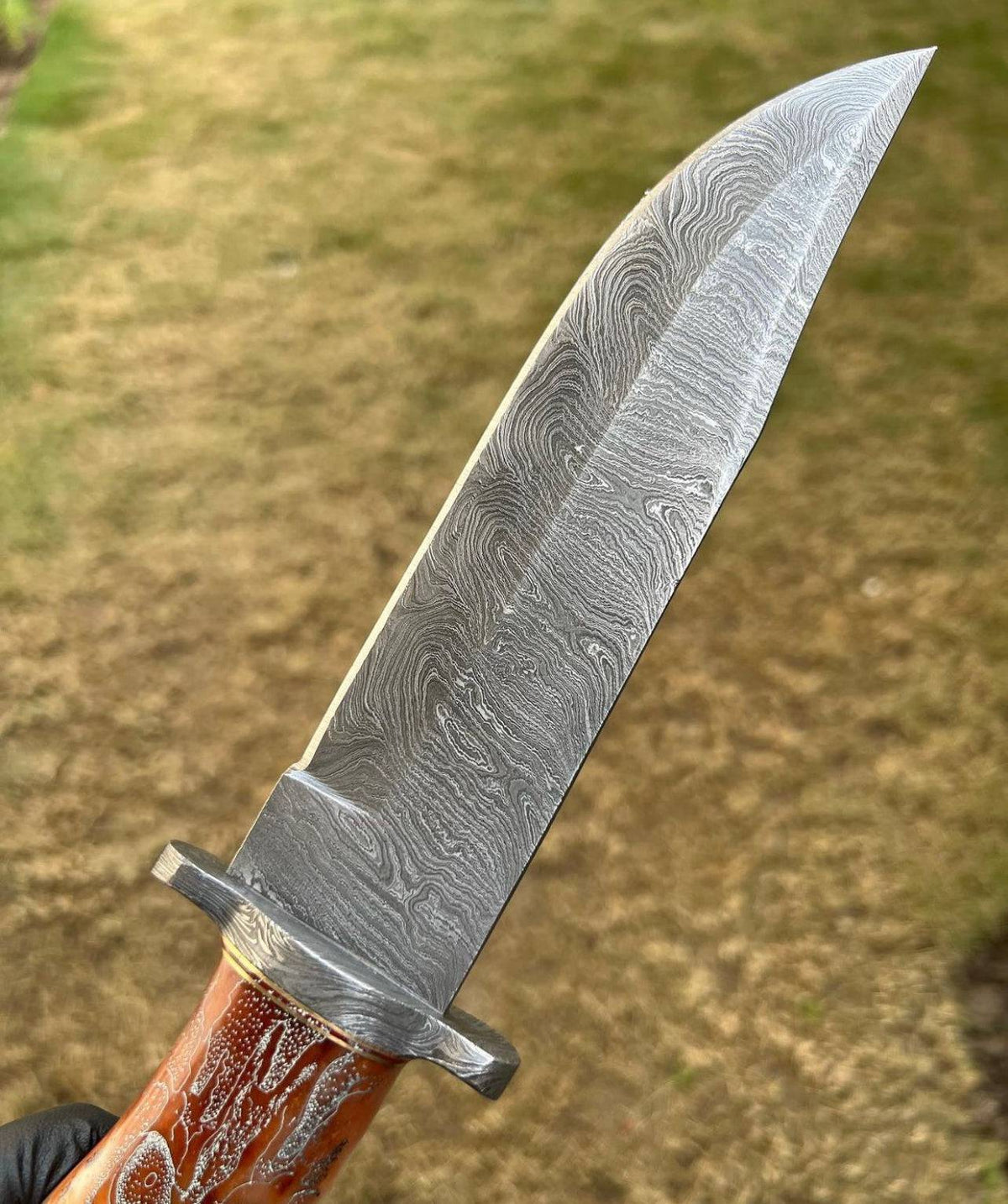 Handmade Damascus hunting knife with skull handle from cskforged, featuring a sharp blade ideal for camping and outdoor activities.