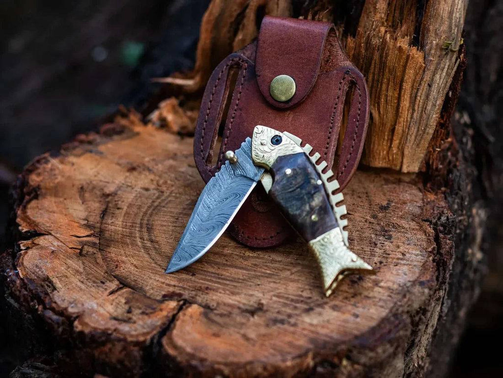 Damascus steel blade fish-shaped pocket folding knife by cskforged, showcasing intricate pattern and compact design.