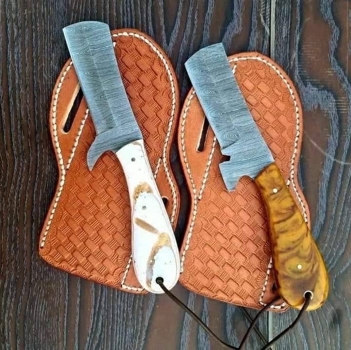 Handmade Damascus steel bull cutter knife by Knives Gear Garage with a detailed patterned blade and sturdy handle.