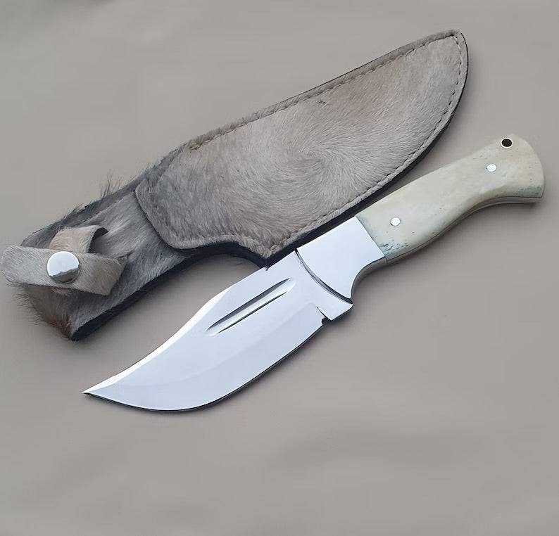 8-inch handmade skinning knife with J2 steel blade and camel bone handle, displayed on a wooden surface.