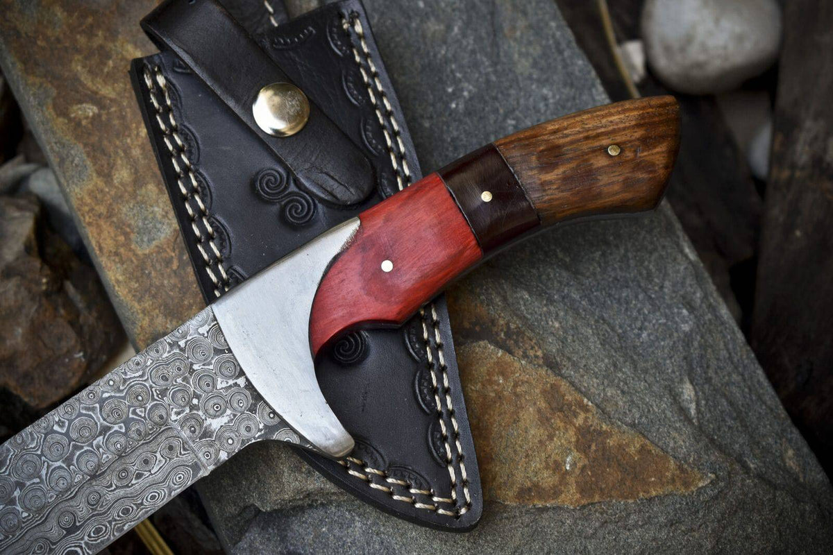 Close-up of Knives Gear Garage handmade Damascus steel hunting knife with pakkawood and rosewood handle and leather sheath.
