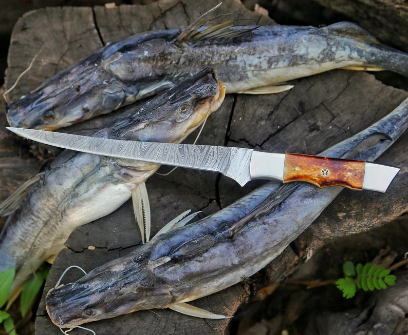 Close-up of a 13-inch Damascus steel fillet knife with a camel bone handle from Knives Gear Garage.